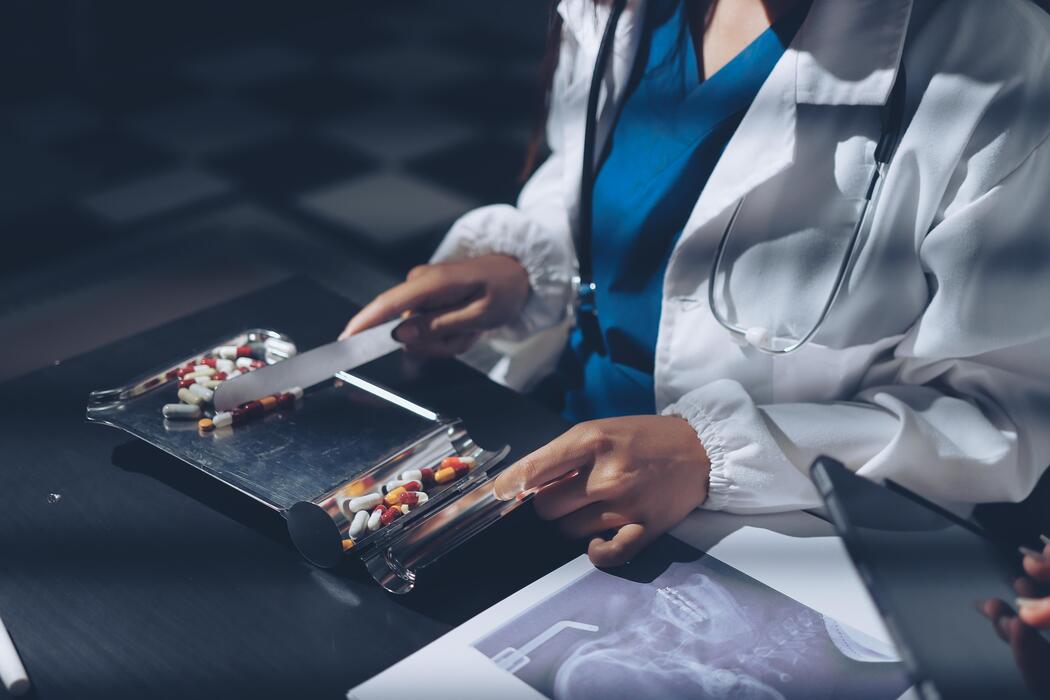 ADHD treatment for adults - A doctor is cutting pills on a tray