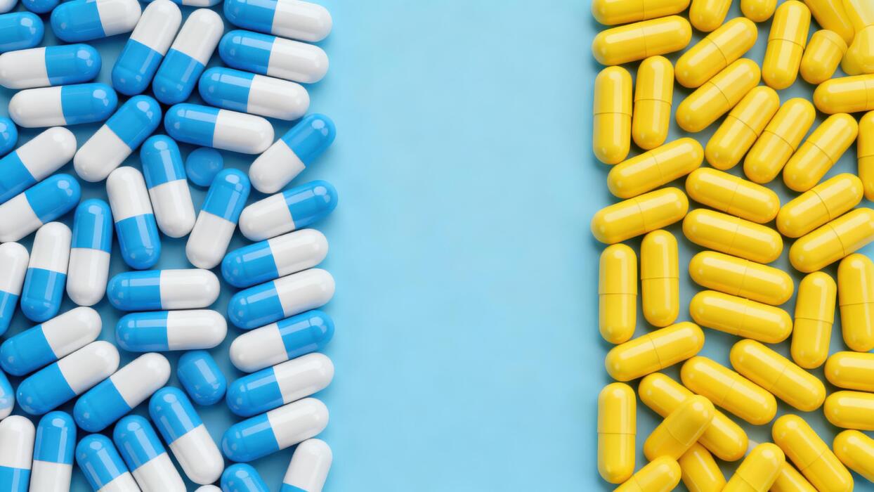 Viagra pills price - Blue and white medicine capsules are grouped on the left and solid yellow capsules are placed on the right side of a light blue background with a central gap.