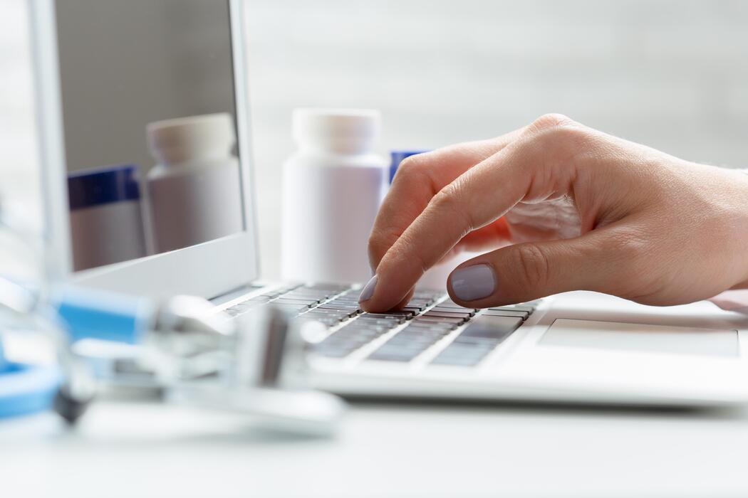 viagra pills online - A person typing on a laptop computer