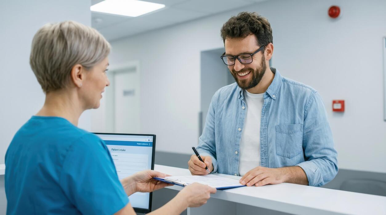 What are 5 symptoms of shingles? - A man and woman are talking at the reception desk