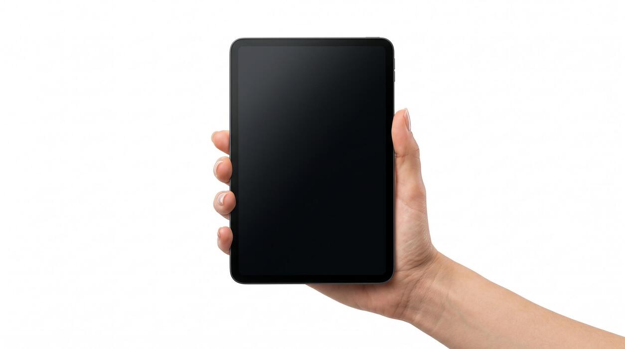 which tablet should i buy uk - A hand holds a blank smartphone screen vertically.