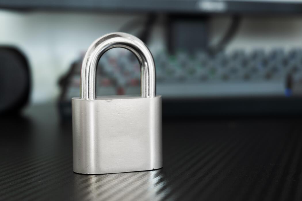 Online pharmacy Login - Silver Padlock on Dark Desk Background