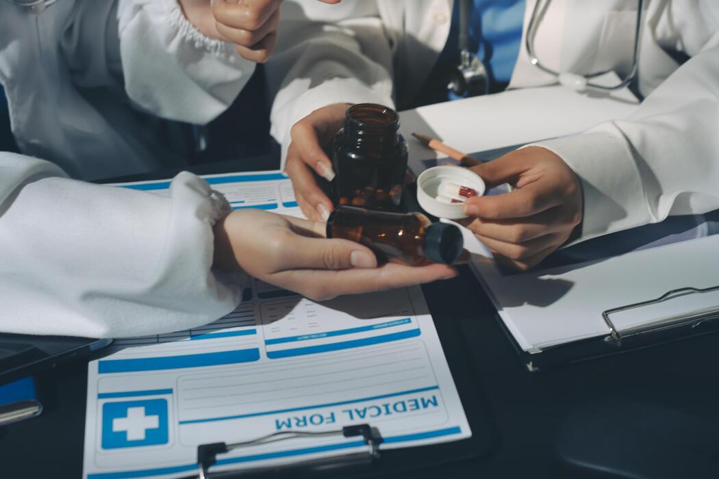 What is the fastest way to stop shingles pain? - A group of doctors holding a bottle of medicine