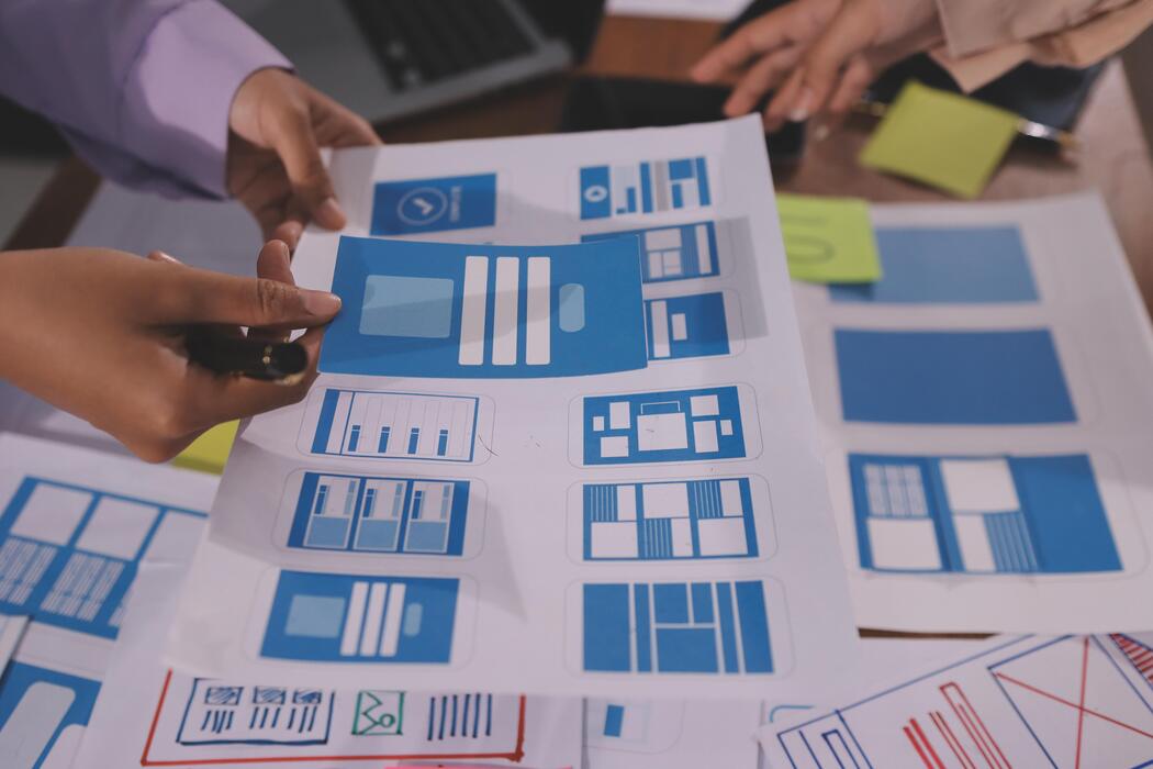 Best website builder for small business free - A group of people are working on a design document