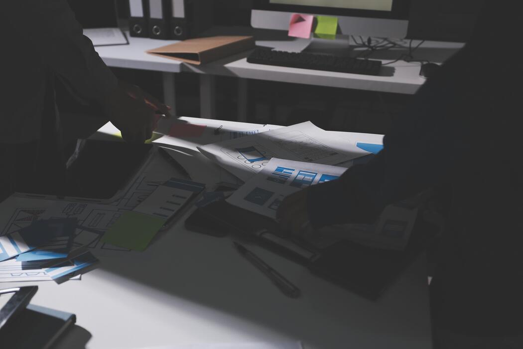 how much does seo cost uk - Two people working on a desk with papers and papers