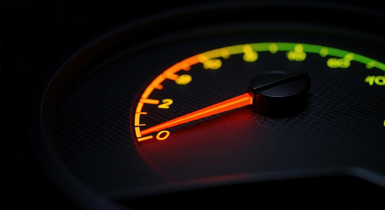 how fast should a small business website be - Illuminated speedometer display close up in dark automotive interior