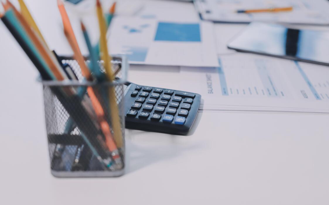 Best small business website design - A calculator, pencils, and pens on a desk