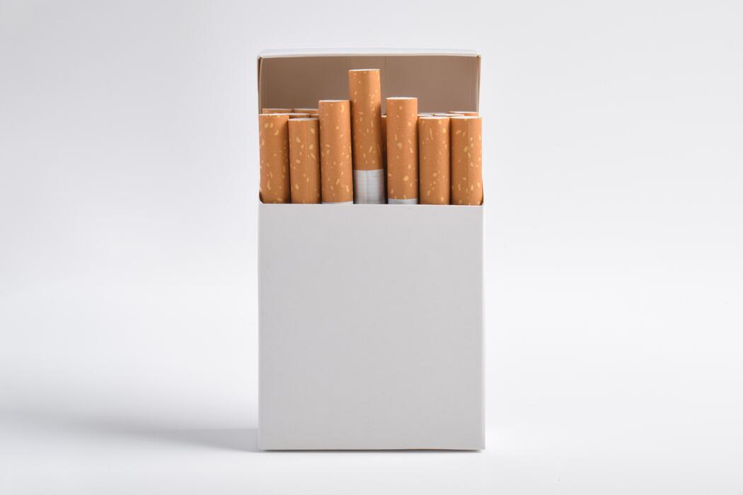 Cigarettes price - Open White Pack of Cigarettes Standing Upright on White Background.