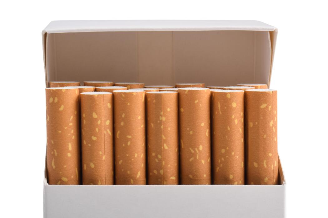 Superkings cigarettes price - Open Pack of Cigarettes with Filtered Ends Visible on White Background.