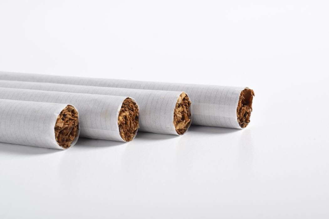 superkings cigarettes australia - Close-up view of four white cigarettes with visible tobacco filling, arranged in a row on a clean white background.