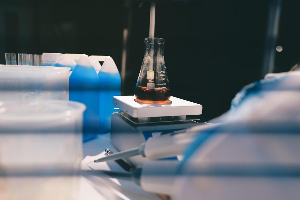 Research peptides UK - A laboratory table with a beaker and a bottle