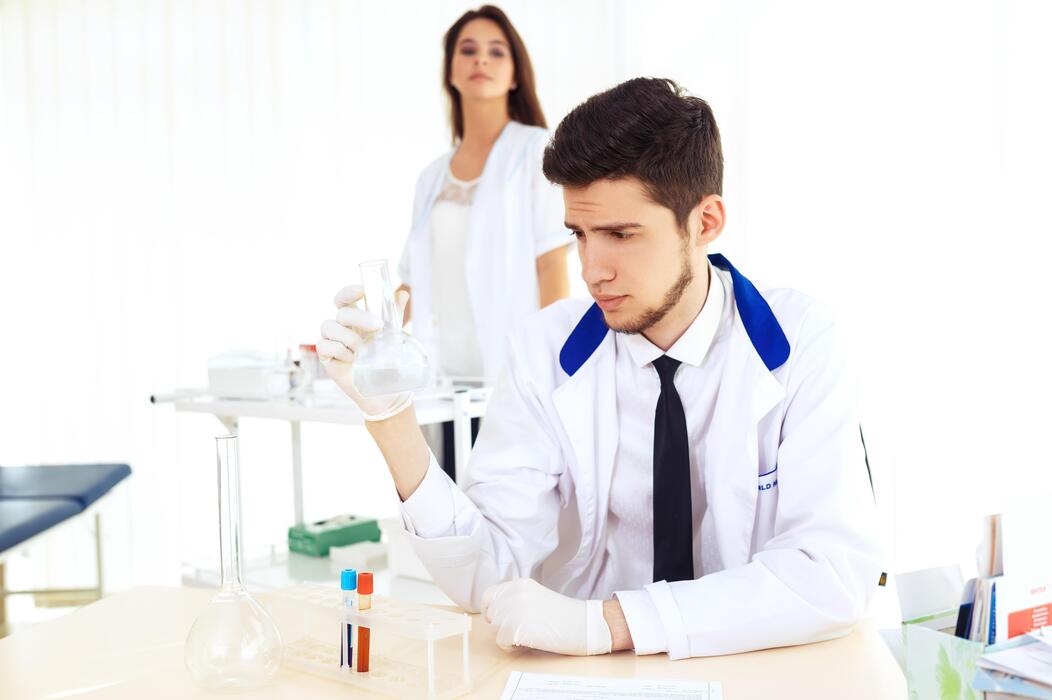 Research peptides for sale - team of researchers collaborating in the lab Laboratory idea featuring Caucasian male scientist.